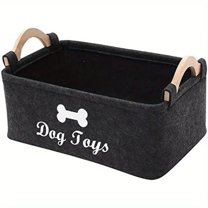 Black storage basket with wooden handles labeled 'Dog Toys' on a white background